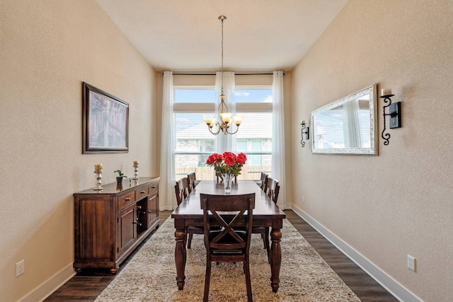629 Asher Ct, Leander, TX 78641 - dining space featuring a chandelier, dark wood finished floors, and a textured wall