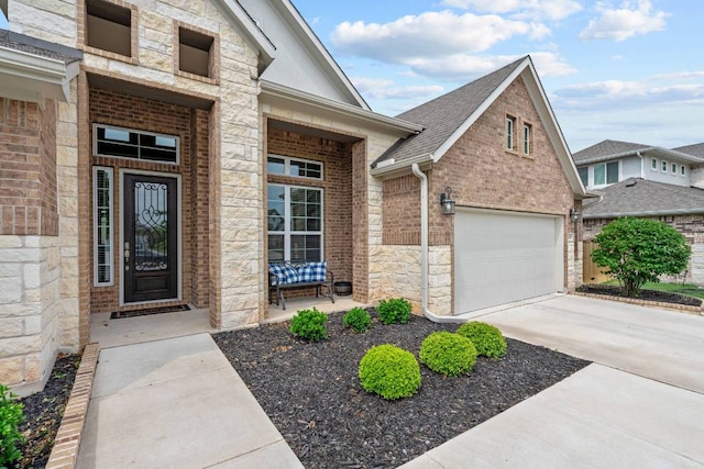 629 Asher Ct, Leander, TX 78641 - view of exterior entry with stone siding, driveway, brick siding, a porch, and a shingled roof