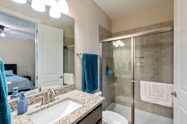 629 Asher Ct, Leander, TX 78641 - ensuite bathroom featuring vanity, a stall shower, ceiling fan, and a textured wall