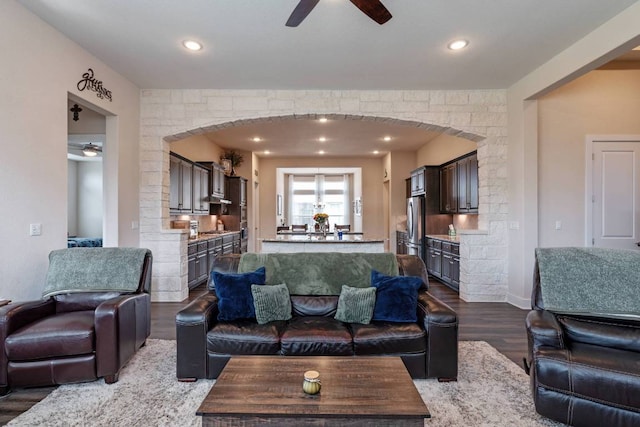629 Asher Ct, Leander, TX 78641 - living area featuring ceiling fan, dark wood-style flooring, arched walkways, and recessed lighting
