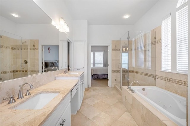 ensuite bathroom featuring a shower stall, double vanity, a jetted tub, and tile patterned floors