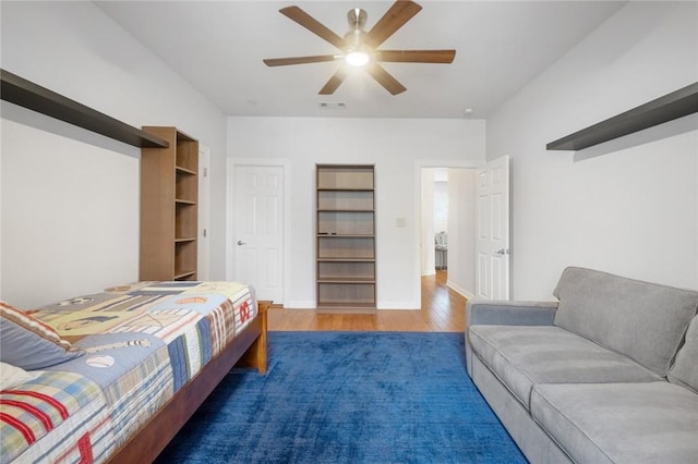 bedroom featuring wood finished floors and a ceiling fan