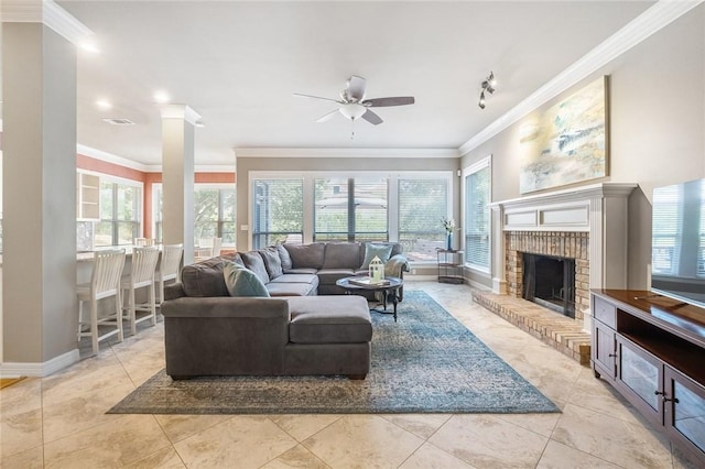 living room featuring crown molding, ceiling fan, baseboards, light tile patterned flooring, and a fireplace