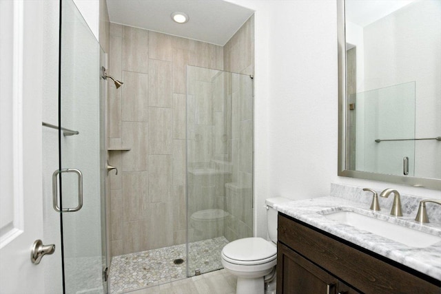 full bathroom with recessed lighting, vanity, toilet, and a stall shower
