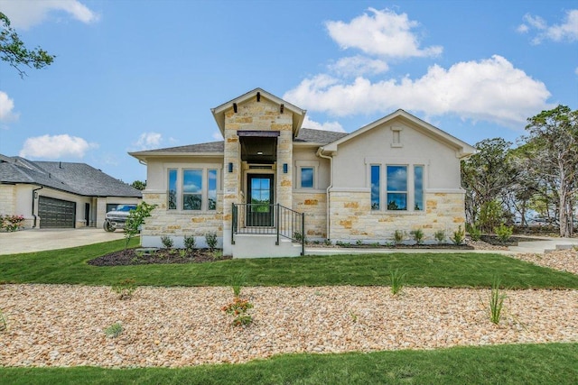view of front of home featuring stucco siding, a front lawn, stone siding, and concrete driveway