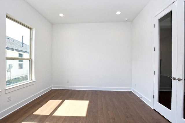 spare room with baseboards, dark wood-style floors, and recessed lighting