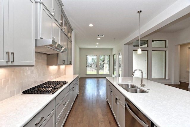 kitchen featuring appliances with stainless steel finishes, gray cabinetry, a sink, and light countertops