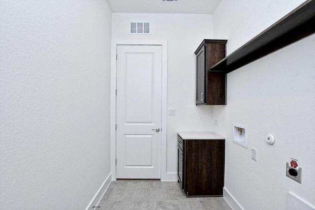 clothes washing area featuring hookup for a washing machine, hookup for an electric dryer, cabinet space, baseboards, and visible vents