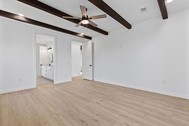 208 Ulupau Cir, Bastrop, TX 78602 - unfurnished bedroom with beamed ceiling, light wood-type flooring, ensuite bathroom, and recessed lighting