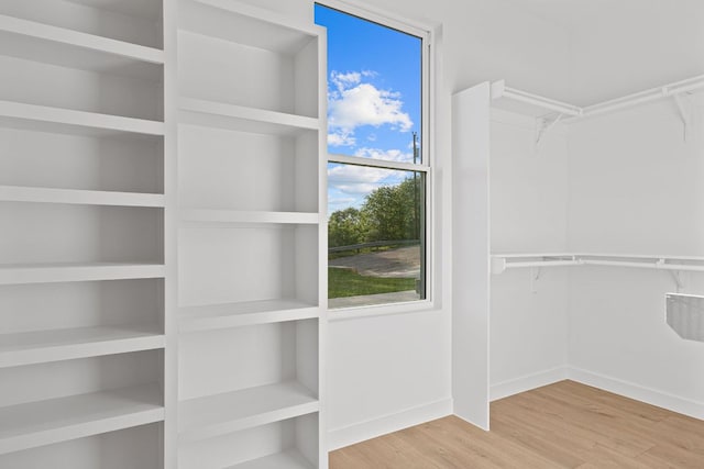 208 Ulupau Cir, Bastrop, TX 78602 - walk in closet featuring wood finished floors