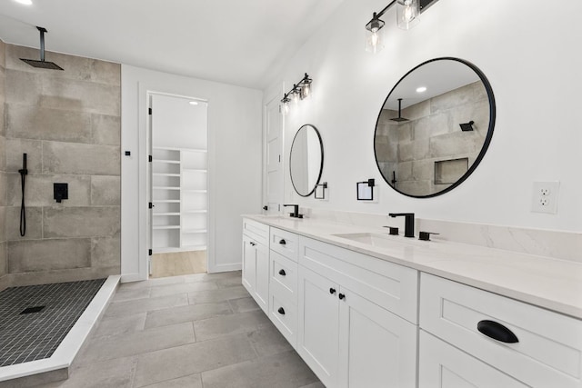 208 Ulupau Cir, Bastrop, TX 78602 - bathroom featuring double vanity, a walk in shower, and a walk in closet