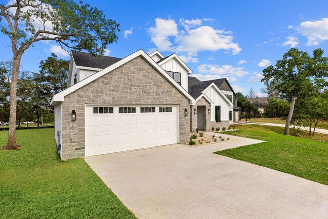 208 Ulupau Cir, Bastrop, TX 78602 - view of front of house featuring board and batten siding, stone siding, concrete driveway, and an attached garage