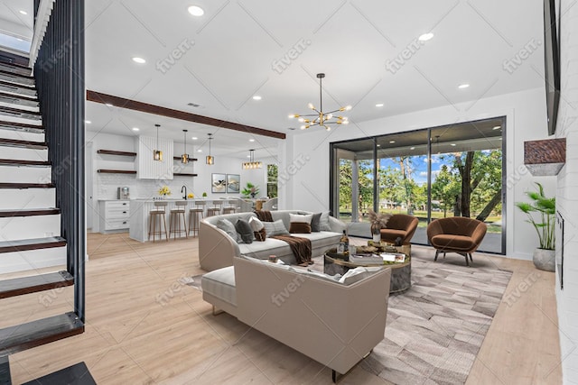 208 Ulupau Cir, Bastrop, TX 78602 - living room featuring stairway, a chandelier, recessed lighting, and light tile patterned floors
