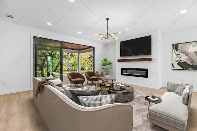 208 Ulupau Cir, Bastrop, TX 78602 - living room with a large fireplace, wood finished floors, a chandelier, recessed lighting, and baseboards