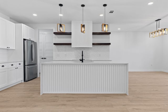 208 Ulupau Cir, Bastrop, TX 78602 - kitchen with open shelves, freestanding refrigerator, decorative backsplash, light countertops, and recessed lighting