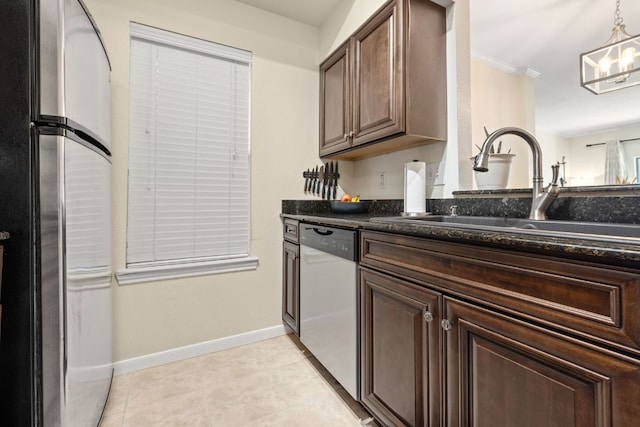 6000 Shepherd Mountain Cv Unit 302, Austin, TX 78730 - kitchen with dishwasher, freestanding refrigerator, a sink, baseboards, and dark brown cabinetry