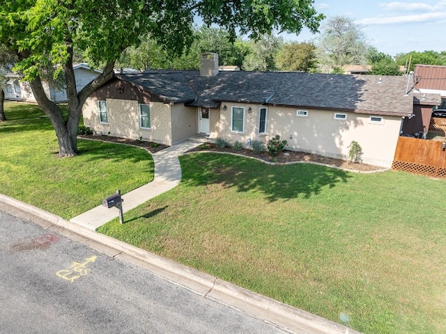 110 Live Oak St, Gonzales, TX 78629 - single story home with brick siding, a front yard, a chimney, and fence