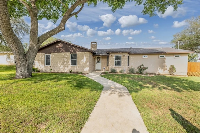 110 Live Oak St, Gonzales, TX 78629 - ranch-style home with brick siding, a front yard, and fence