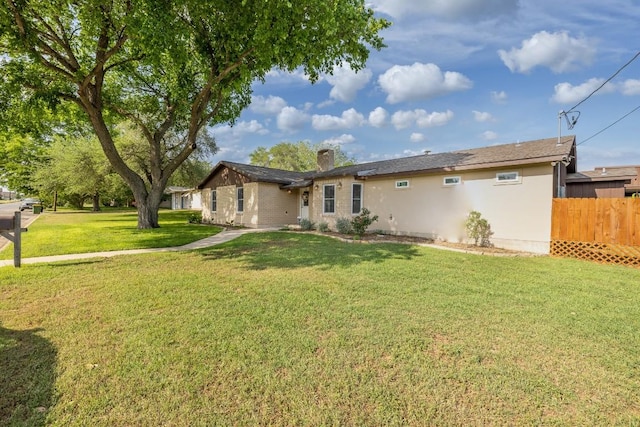 110 Live Oak St, Gonzales, TX 78629 - rear view of house with fence and a lawn