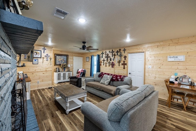 110 Live Oak St, Gonzales, TX 78629 - living area featuring dark wood-style flooring, visible vents, recessed lighting, a ceiling fan, and wood walls