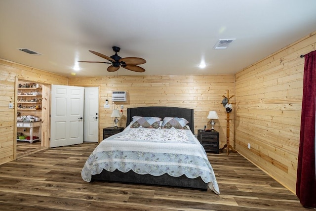 110 Live Oak St, Gonzales, TX 78629 - bedroom with dark wood finished floors, visible vents, and wood walls
