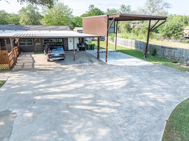 110 Live Oak St, Gonzales, TX 78629 - view of parking featuring fence, driveway, and a detached carport