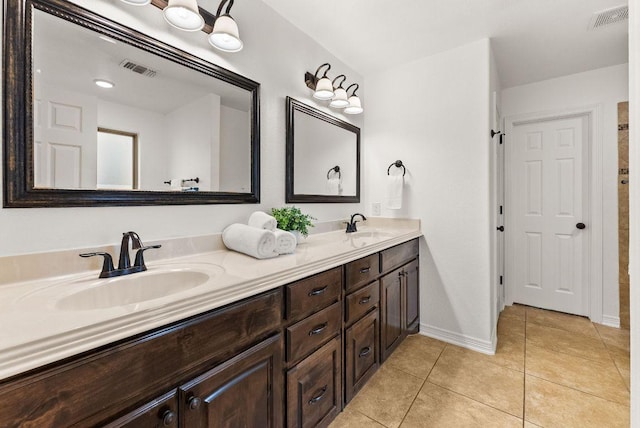 full bath featuring tile patterned floors, visible vents, a sink, and double vanity