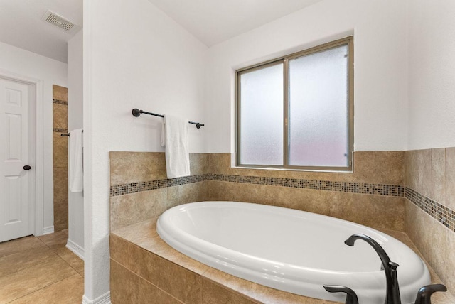full bathroom with a garden tub, visible vents, and tile patterned flooring