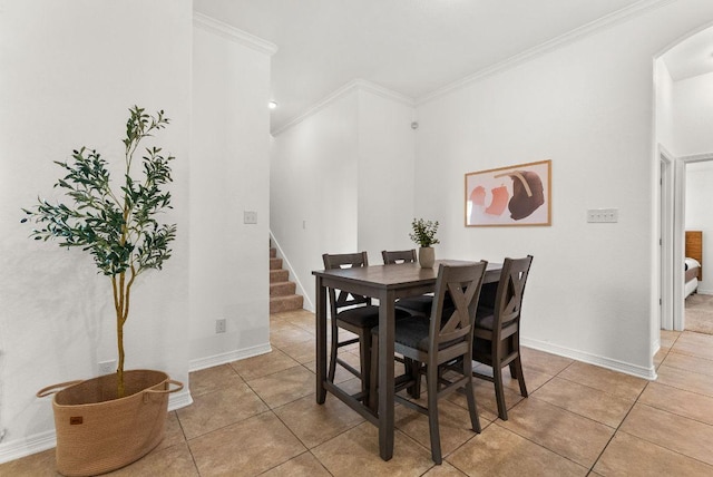 dining space with arched walkways, light tile patterned flooring, baseboards, stairs, and crown molding