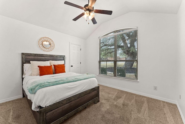 carpeted bedroom with lofted ceiling, a ceiling fan, and baseboards