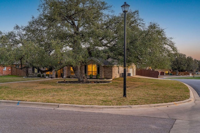 obstructed view of property with a front lawn and driveway