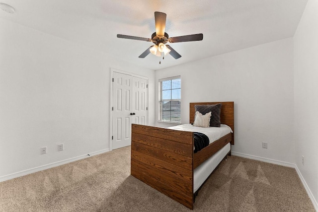bedroom featuring carpet, a closet, a ceiling fan, and baseboards