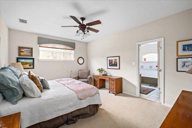 carpeted bedroom with baseboards, a ceiling fan, visible vents, and connected bathroom