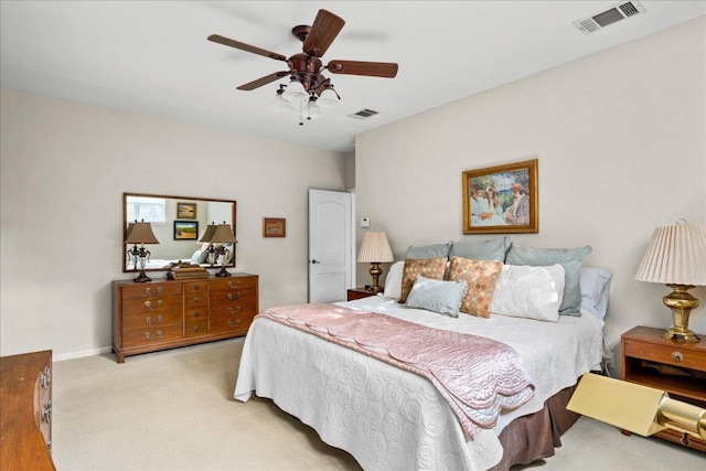 bedroom with carpet floors, a ceiling fan, and visible vents
