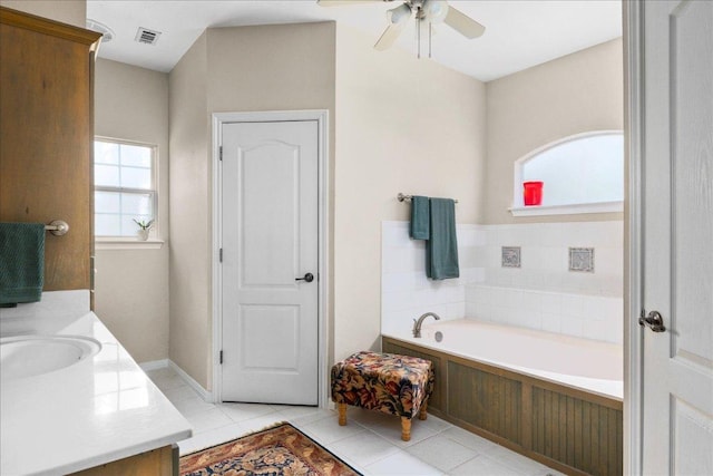 full bath with tile patterned flooring, visible vents, vanity, a bath, and ceiling fan