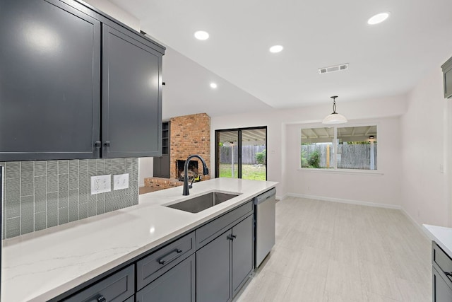 1337 Neans Dr, Austin, TX 78758 - kitchen with stainless steel dishwasher, a sink, visible vents, decorative backsplash, and pendant lighting