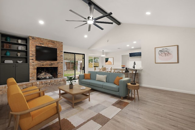 1337 Neans Dr, Austin, TX 78758 - living area with ceiling fan, light wood-style floors, beamed ceiling, baseboards, and a fireplace