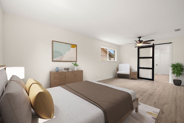 1337 Neans Dr, Austin, TX 78758 - bedroom featuring light wood-style floors, baseboards, ceiling fan, and a barn door