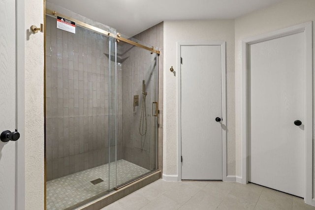1337 Neans Dr, Austin, TX 78758 - full bath with baseboards, tile patterned flooring, and a shower stall