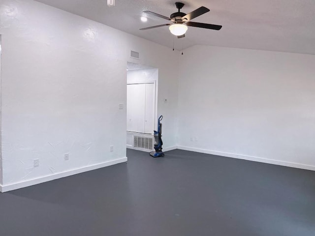 spare room featuring baseboards, a ceiling fan, visible vents, and concrete floors
