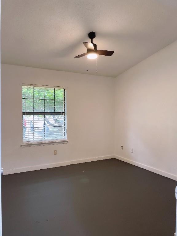unfurnished room featuring baseboards and ceiling fan