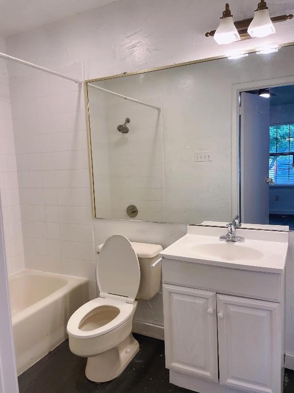 bathroom with toilet, vanity, and bathing tub / shower combination