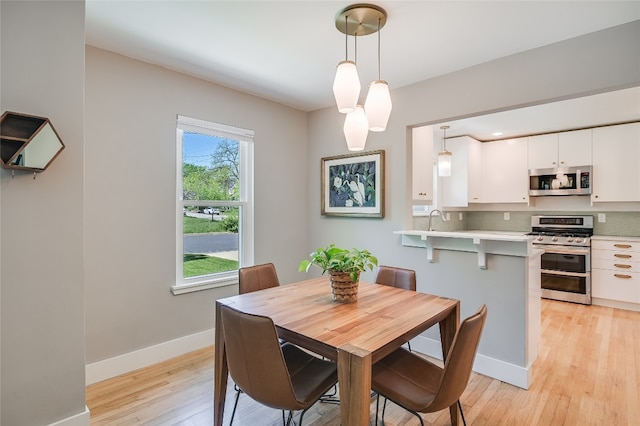 6307 Camino Real Unit 1, Austin, TX 78757 - dining area featuring baseboards and light wood-style flooring