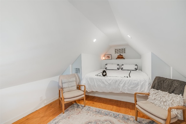 6307 Camino Real Unit 1, Austin, TX 78757 - bedroom with lofted ceiling, wood finished floors, and visible vents