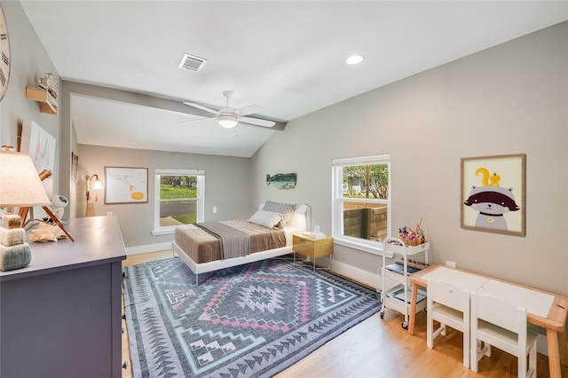 6307 Camino Real Unit 1, Austin, TX 78757 - bedroom with multiple windows, vaulted ceiling, visible vents, and light wood-type flooring