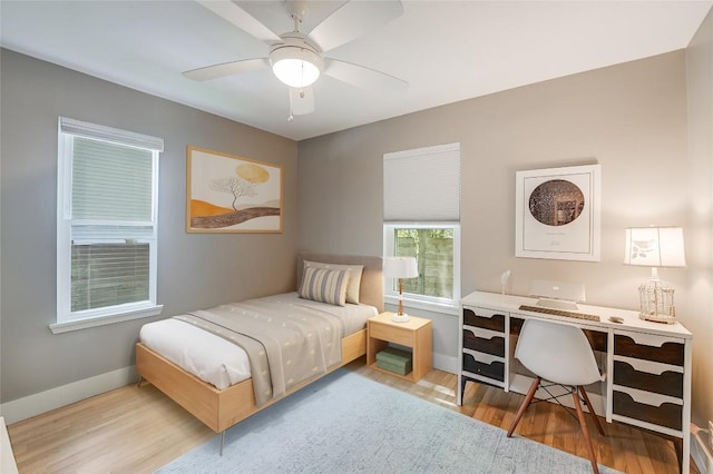 6307 Camino Real Unit 1, Austin, TX 78757 - bedroom with baseboards, a ceiling fan, and wood finished floors