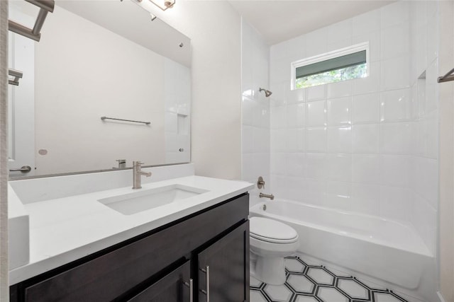 bathroom with toilet,  shower combination, vanity, and tile patterned flooring