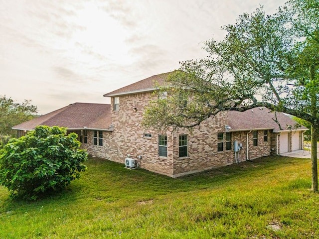 2800 Lomas Rodando Calzada Rd, Kempner, TX 76539 - back of property featuring an attached garage, a lawn, brick siding, concrete driveway, and cooling unit