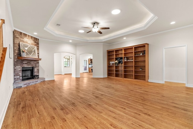 2800 Lomas Rodando Calzada Rd, Kempner, TX 76539 - unfurnished living room with arched walkways, a tray ceiling, ceiling fan, light wood-type flooring, and recessed lighting