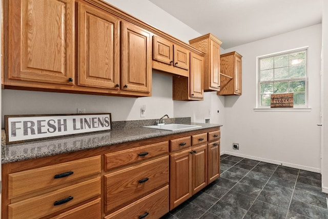 2800 Lomas Rodando Calzada Rd, Kempner, TX 76539 - kitchen featuring a sink, baseboards, and brown cabinets